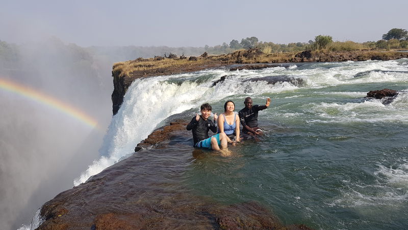 Visitors_at_the_Devil-s_Pool__Victoria_Falls