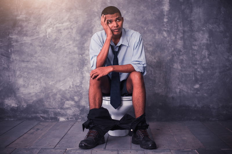 Man sitting on toilet