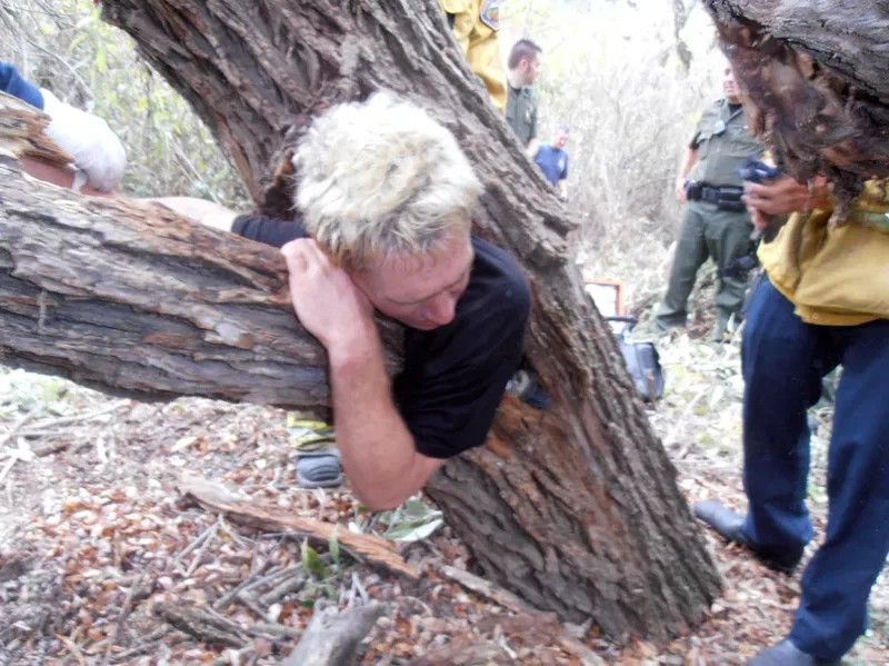 man_wedged_in_tree